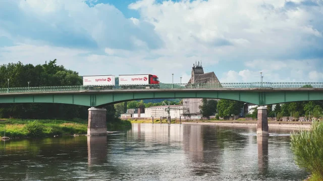 Ein LKW mit Symrise Firmenlogo, welcher über eine Brücke fährt